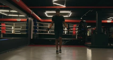 Training of a young boxer with a rope. Video stock 275279791