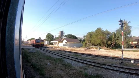 Trains that are driving through train station slowly at Phetchaburi Station Stock Footage 131586964
