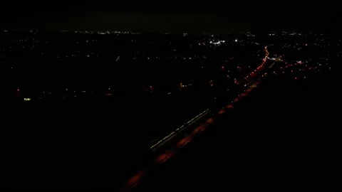 Trains Crossing at Night Multiple while panning to reveal city village windows Stock Footage 231575431