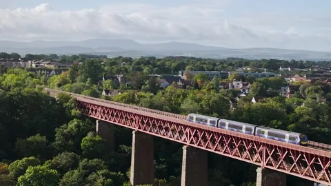 Trains on Forth Bridge from a drone, Queensferry Crossing, Scotland Stock-Footage 317099788