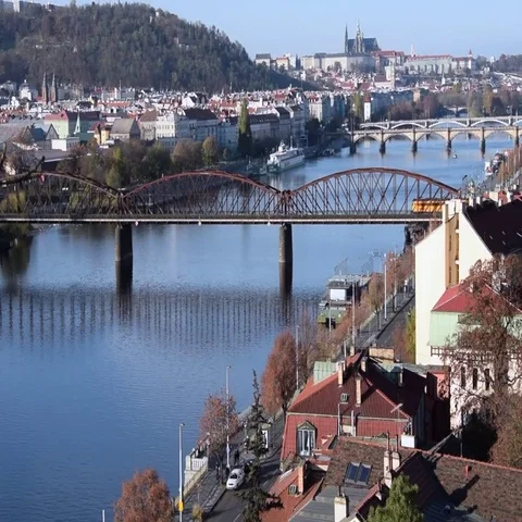 Trains pass on Vysharad bridge. Prague castle is visible in the background Stock Footage