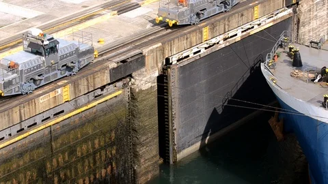 Trains pulling a oil tanker ship through the locks in Gatun Panama. Stock Footage 88542295