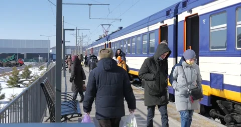 Trains wait for the passengers. People walking near the train. Winter day. Stock Footage 222963471