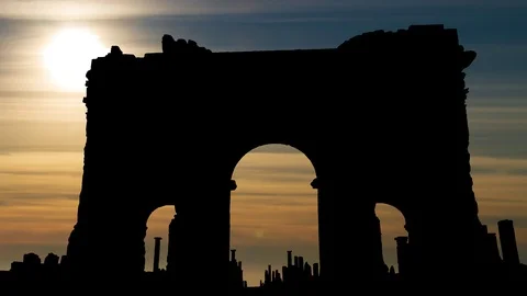 Trajan's Arch in ruins of Timgad, Time Lapse at Sunset, Algeria Stock Footage 107768997