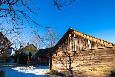 Trakai, Lithuania - 01 08 22: old wooden rural houses covered with snow and Stock Photos