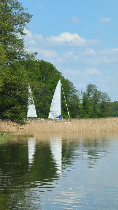Trakai, Lithuania, 12 may 2023 Sailboats meet on lake Stock Footage 259052292