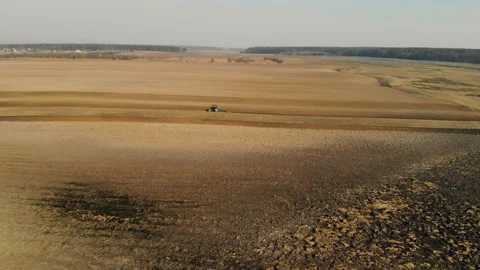 Trakor plows the land in early spring. The view from the top. Agricultural work Stock Footage 106373773