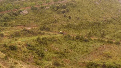 Traktor passing trough mountains Stock Footage 98006125