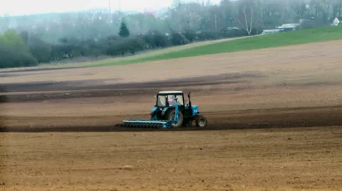 Traktor plows the land in spring Stock Footage 38018317
