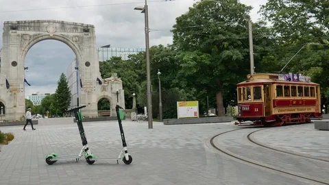 Tram City Tour Loop in New Zealand and lime electric scooter Stock Footage 104693264