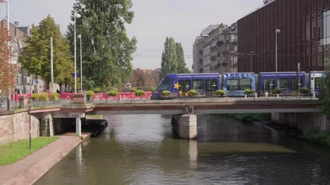 Tram crossing a bridge over the water in Strasbourg, France Europe public Stock Footage 345364435