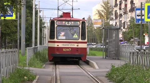 Tram departs from a stop at single-track fenced segregation in Sosnovaya Polyana Stock Footage 67468256