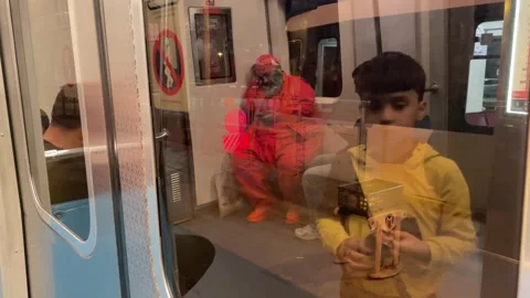 Tram door closes with a caution beep, a child and a man appear on the glass Stock Footage 271299728