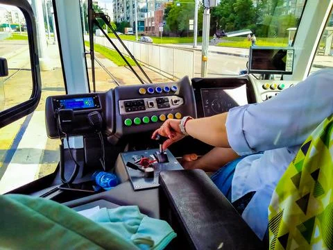 Tram driver at work drives a tram in the summer in the city Stock Photos