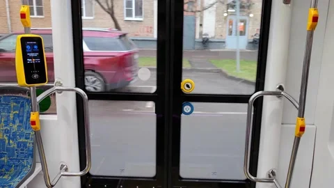 The tram goes along the route. View the city through transparent automatic doors Stock Footage 164827593