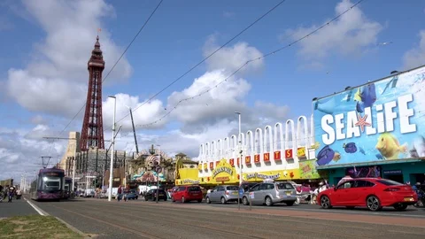 Tram going through black town center at the waterfront area Stock Footage 118279347