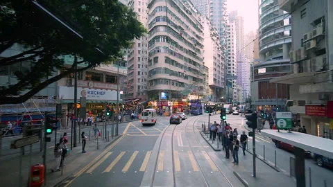 The tram going through the narrow streets of the metropolis Hong Kong Stock-Footage 137943618