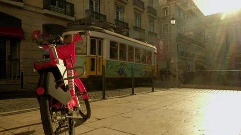 Tram leaving a stop in Praca Luis de Camoes at sunrise. Stock Footage 120064939