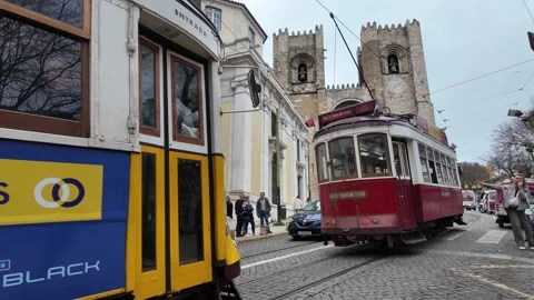 Tram Moving with Lisbon Cathedral in Background Stock Footage 297580467