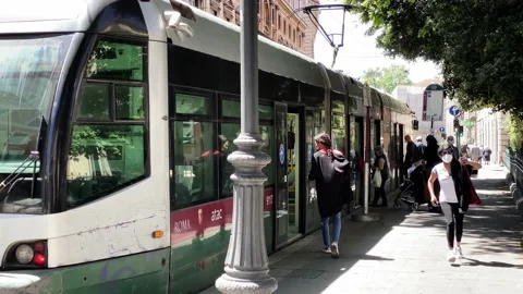 Tram opening the sliding doors at the stop and people entering. Stock Footage 156183751