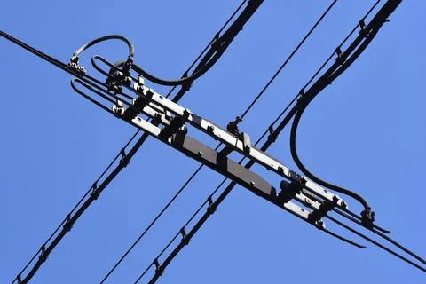Tram overhead line intersection switch against blue sky Stock Photos