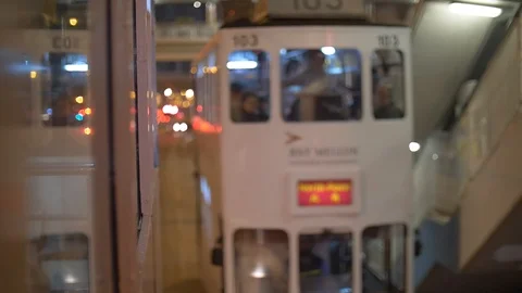 Tram passes by another train through on Hong Kong tramway 4k Stock Footage 123141391