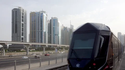 Tram passing along Sheikh Zayed Road in Dubai, UAE Stock Footage 100741635
