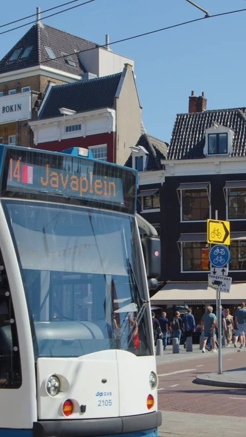 Tram Passing Busy Amsterdam Intersection With Cyclists and Pedestrians Stock Footage 316462228
