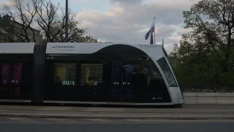 Tram passing by on a busy intersection at Hamilius station in Luxembourg Stock Footage 280026378