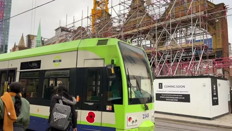 A Tram passing a construction site in West Croydon, UK, 4K Stock Footage 171409159