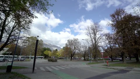 Tram passing on empty roundabout with mountains in the back Stock Footage 262062666