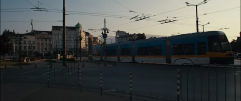 Tram passing through old city junction during sunset. Stock Footage 252265840
