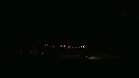 The tram pulls away from the stop in complete darkness. Stock Footage 231706172