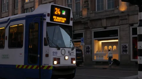 Tram pulls away from stop on Damrak, Amsterdam Stock Footage 57212125