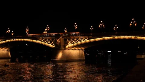 The tram rides on the night bridge in Budapest,  Hungary. Stock-Footage 78874152