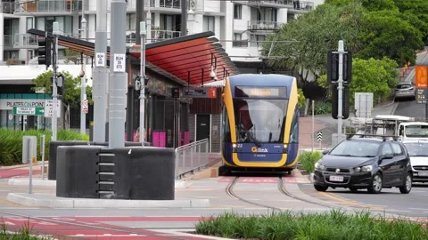 Tram stopped at the tram and bus interchange in Burleigh Heads as cross the Stock Footage 346908044