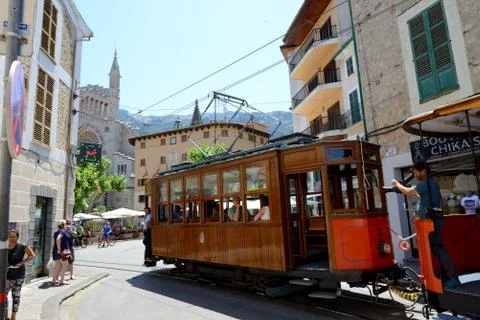 The tram is on street of Soller town and tourists Stock Photos