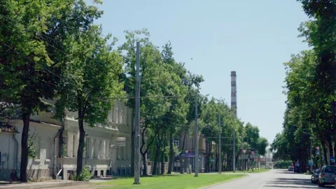 Tram tracks and overhead power lines along tree lined street in Daugavpils Stock Footage 342685593