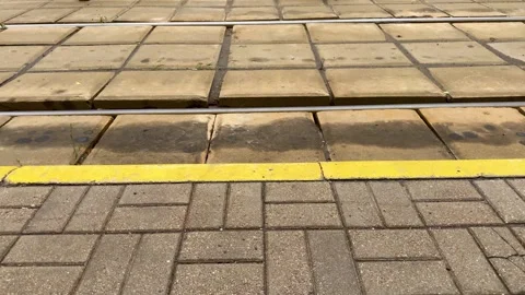 Tram tracks and platform edge with yellow safety line Vidéo 339723739