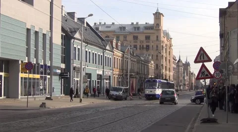 Tram train runs along cobble-paved Kr. Barona Street in city center Stock Footage 64639051