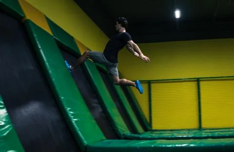 Trampoline jumper performs acrobatic exercises on the trampoline Foto stock