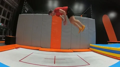 Trampoline Jumping Backflip Practiced by Young Man Slow Motion Stock Footage 102220076