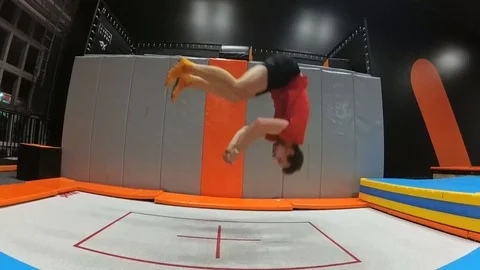 Trampoline Jumping Tricks Practiced by Young Man Slow Motion Stock Footage 102220237