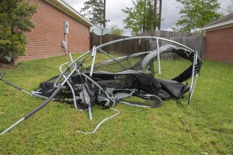 Trampoline twisted and mangled after storm. Stock Photos