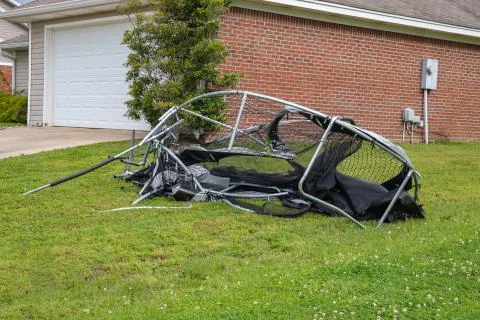 Trampoline twisted and mangled after storm. Stock Photos