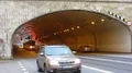 Trams and other vehicles hurrying, moving out from under bridge on wide motorway HD Footage