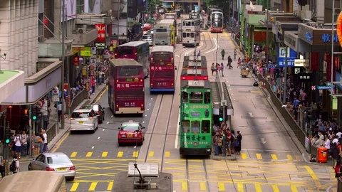 TRAMS BUSES ON DES VOEUX CENTRAL HONG KONG Stock Footage 76691681
