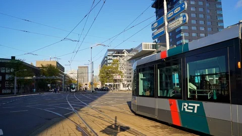 Trams crossing each other leaving the Erasmus bridge seen in the direction of Stock Footage 126060324