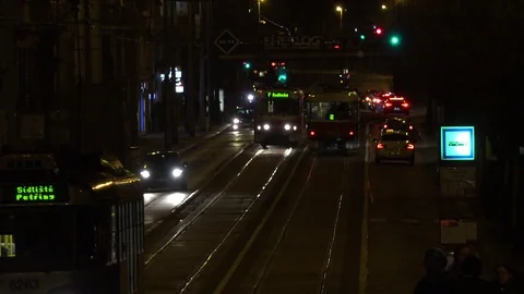 Trams drive up and down a road in a street at night Stock-Footage 79534499