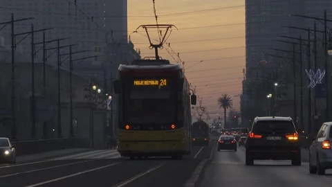 Trams going along the street in sunset Stock Footage 147626964